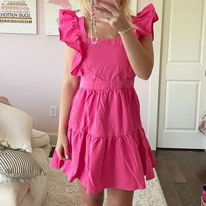 cute pink ruffle dress with bow on back!